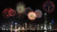a fireworks display over a city at night at Four Seasons Hotel Hong Kong in Hong Kong