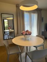 a dining room with a table and chairs and a mirror at Résidence CATALINA in Saint-Florent