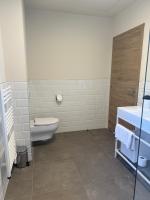 a bathroom with a toilet and a sink at Résidence CATALINA in Saint-Florent