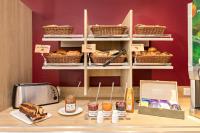 a bakery counter with pastries and a toaster and bread at Ace Hôtel Salon de Provence in Salon-de-Provence