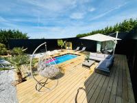a wooden deck with a swing and a swimming pool at Evasion tropicale in Bretteville-sur-Odon