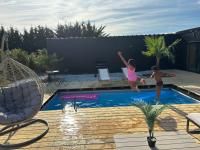 two children jumping into a swimming pool at Evasion tropicale in Bretteville-sur-Odon