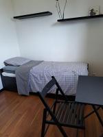 a bedroom with a bed and a chair with a laptop at Chambre Solo Duo 20 min Paris - G in Drancy