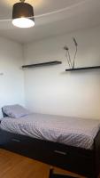 a bedroom with a bed with a plant on the wall at Chambre Solo Duo 20 min Paris - G in Drancy