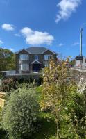 a large house on top of a hill with trees at Carrick Gate in Carrick