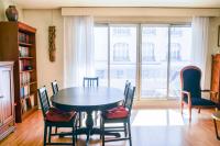 a dining room with a table and chairs and a window at Cozy 58 m near Butte-aux-Cailles in Paris