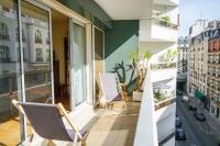 a balcony with chairs and a view of a city at Cozy 58 m near Butte-aux-Cailles in Paris