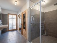 a bathroom with a glass shower and a sink at Haus Lilyan in Donnersbachwald