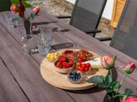 a wooden table with a plate of food and fruit at Haus Lilyan in Donnersbachwald