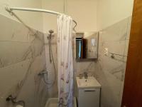 a bathroom with a shower curtain and a sink at Apartments by the sea Jezera, Murter - 5123 in Jezera