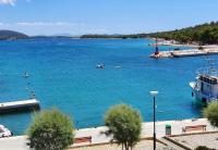 a large body of water with a boat in it at Apartments by the sea Jezera, Murter - 5123 in Jezera