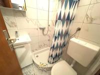 a bathroom with a toilet and a shower curtain at Apartments by the sea Jezera, Murter - 5123 in Jezera