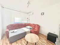 a living room with a red couch and a table at Apartments by the sea Jezera, Murter - 5123 in Jezera