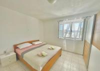 a small bedroom with a bed and a window at Apartments by the sea Jezera, Murter - 5123 in Jezera