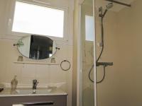 a bathroom with a shower and a sink and a mirror at Holiday Home Penn Ar Bed - PBA114 by Interhome in Pleubian