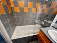 a bathroom with a shower and a tub and a sink at San José in Juvignac