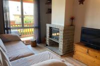 a living room with a fireplace and a television at Casita Planes Surroca in Bourg-Madame
