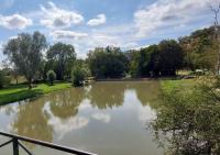 a pond in the middle of a park at B&amp;B Bon Vivant in Brinay
