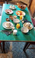 a green table with plates of food and glasses of orange juice at B&amp;B Bon Vivant in Brinay