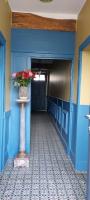 a blue hallway with a vase with flowers in it at B&amp;B Bon Vivant in Brinay
