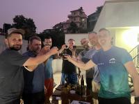 a group of men holding up glasses of wine at The Sparkling Turtle Backpackers Hostel in Kathmandu
