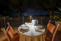 a table sitting on a balcony at night at Tra gli Alberi e il Mare in Sirolo