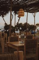 a wooden table and chairs with a light fixture at Dreamsea Imsouane Morocco in Imsouane