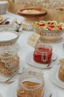 a table topped with bowls of food and jars of jam at Dreamsea Imsouane Morocco in Imsouane