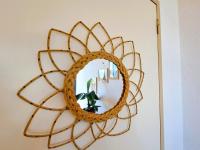 a gold mirror on a wall with a plant at Appartement Pra-Loup, 3 pièces, 6 personnes - FR-1-165A-54 in Uvernet