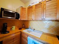 a kitchen with a sink and a microwave at Appartement Pra-Loup, 3 pièces, 6 personnes - FR-1-165A-54 in Uvernet