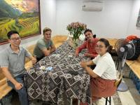 a group of people sitting around a table at Central Sapa Serenity Homestay in Sa Pa