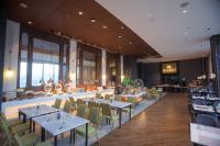 a restaurant with tables and chairs and a bar at Grand Summit Hotel General Santos in General Santos