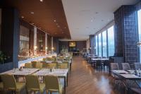 a dining room with tables and chairs and windows at Grand Summit Hotel General Santos in General Santos