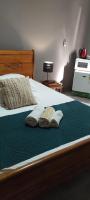 a bed with two towels and two books on it at Bois de Santal Chambre d&#39;hôtes in Saint-Pierre