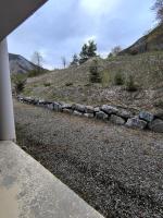 a stone retaining wall on the side of a hill at studio tout équipé in Jausiers