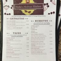 a menu for a restaurant on a table at Oasis Inn & Suites 29 Palms Hotel Joshua Tree National Park in Twentynine Palms