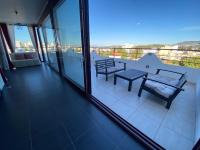 a balcony with a table and chairs and a view at Luxury view apartment 10min from Athens airport in Koropi