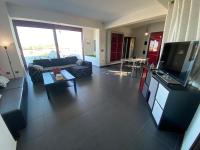 a living room with a couch and a tv at Luxury view apartment 10min from Athens airport in Koropi