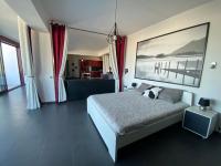 a bedroom with a bed with a large painting on the wall at Luxury view apartment 10min from Athens airport in Koropi