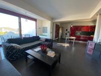 a living room with a couch and a table at Luxury view apartment 10min from Athens airport in Koropi