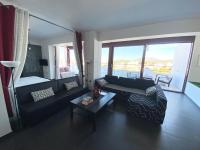 a living room with a couch and a table at Luxury view apartment 10min from Athens airport in Koropi
