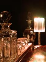 a group of glass jars on a table with a lamp at Casal da Serrana in Óbidos