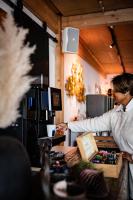 a man standing at a counter in a kitchen at Brouwersdam Stay in Ouddorp