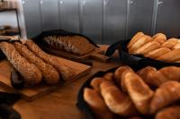a table topped with lots of different types of bread at Brouwersdam Stay in Ouddorp