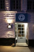 a door to a building with a sign on it at Kittiwake Cottage - Charming harbour-side cottage, luxury interiors in Port Isaac