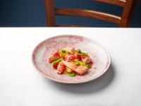 a pink bowl of food on a white table at Kittiwake Cottage - Charming harbour-side cottage, luxury interiors in Port Isaac