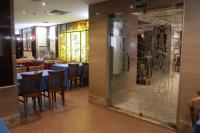 a dining room with tables and chairs and stained glass windows at Emilio Hotel in Luxor