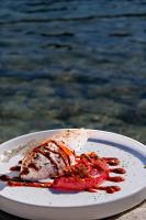 Un plato blanco con un trozo de comida encima. en Hotel Plein Large, en Bandol