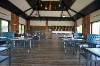 an empty dining room with tables and chairs at E&G Green Courts Resort at Koroli Hill Station in Nashik