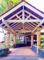 a large wooden pavilion with a brick walkway at Sublime Tahiti Beach Retreat in Mataiea